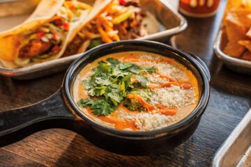 “Torchy’s Green Chile Queso and chips for National Queso Day”