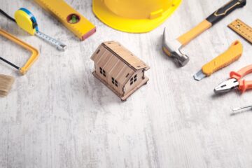 vecteezy_work-tools-with-a-wooden-house-model